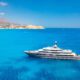 multideck-yacht-in-a-bay-with-azure-water-summer